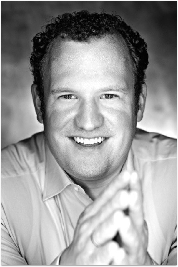 a man putting money into a yellow piggy bank